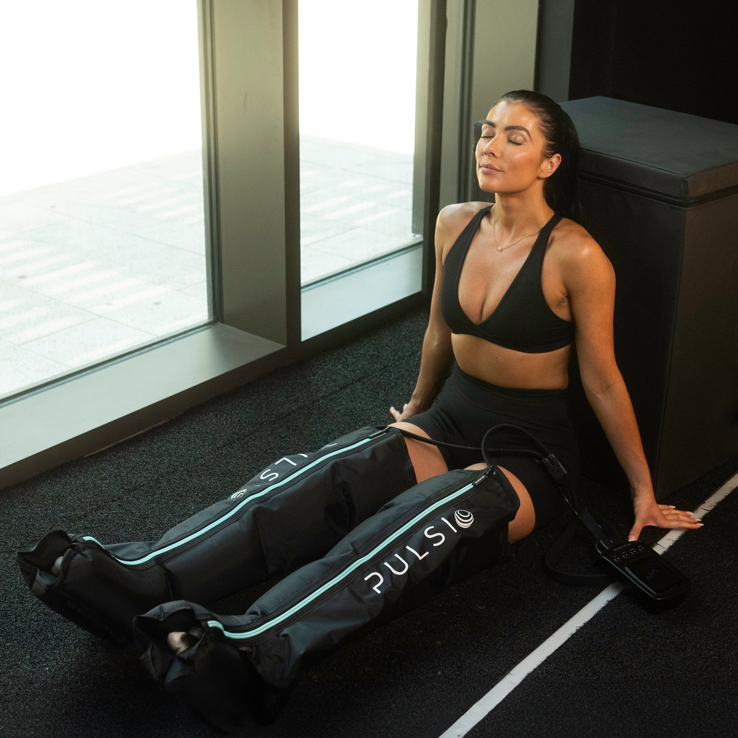 Leg compression sleeves with a massage gun, showing a £149.99 savings offer.