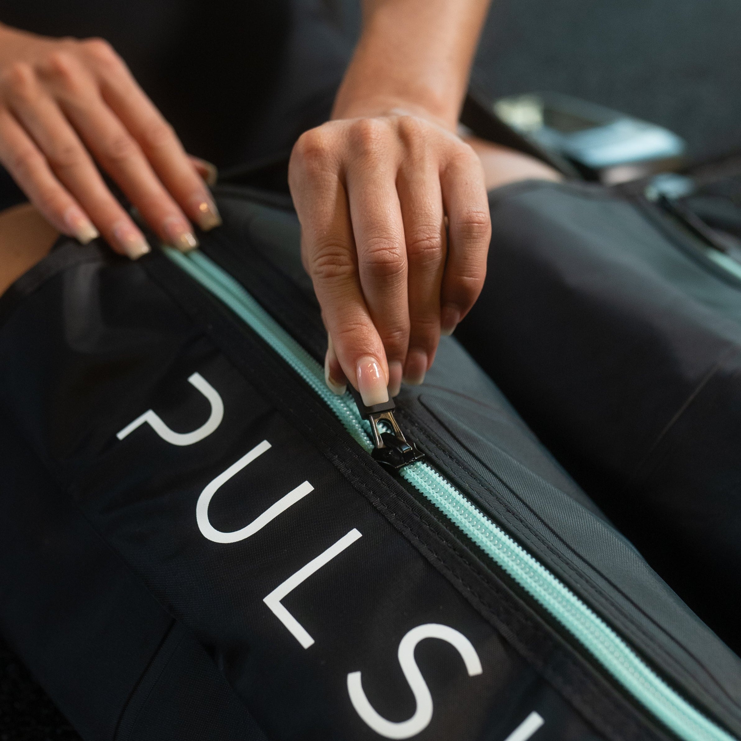 Leg compression sleeves with a massage gun, showing a £149.99 savings offer.