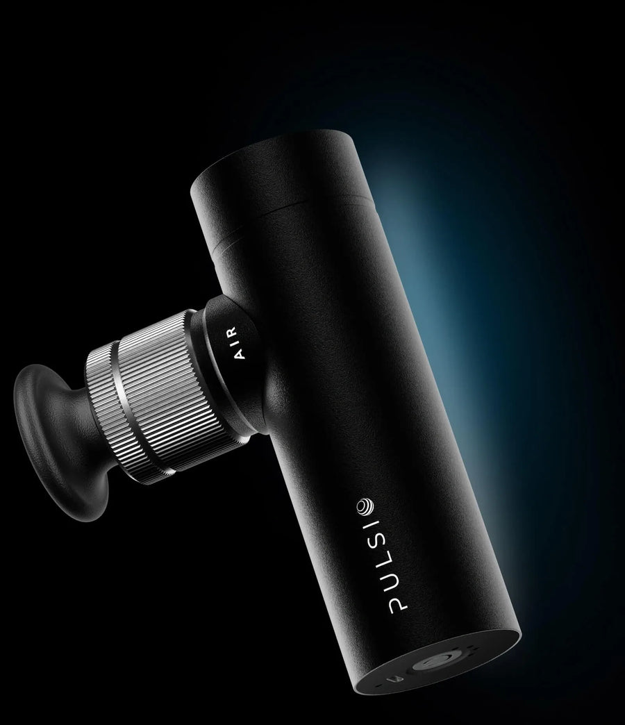 Black massage gun with 'PULSI' branding on a dark background.