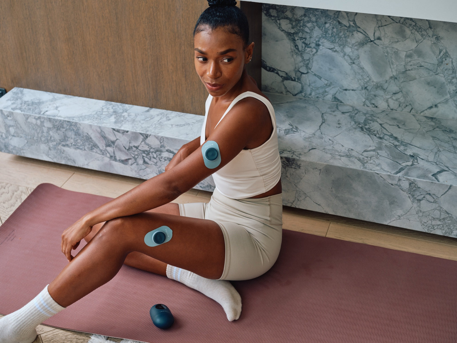 TENS pads in use on the arm and thigh