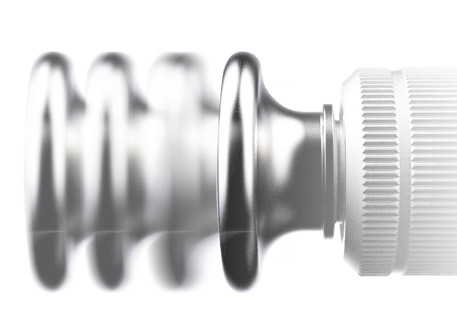 Close-up of a metallic component with detailed grooves and ridges.