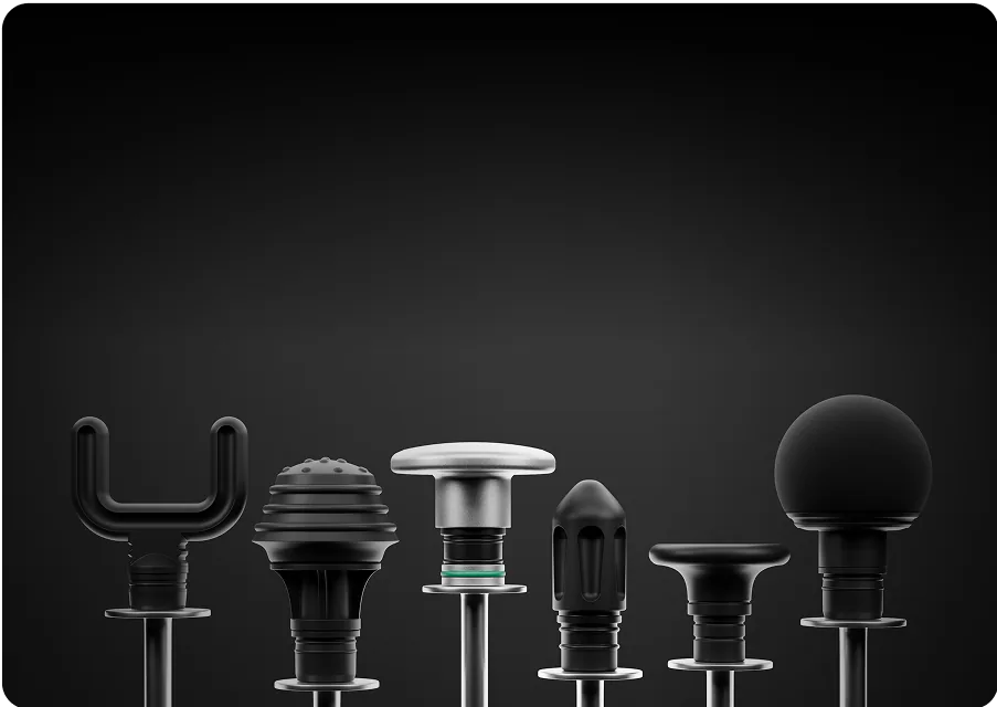 Six different black massage gun attachments on a dark background.